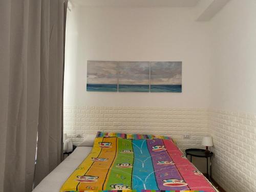 a bed with a colorful quilt on it in a bedroom at Hotel Brivio in Milan