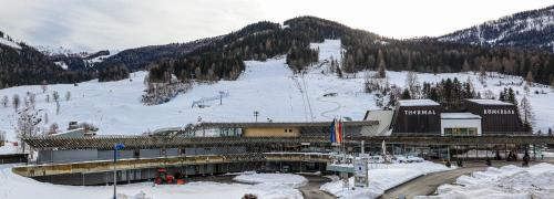 a ski lodge in the snow with a mountain at Appartement Else in Bad Kleinkirchheim