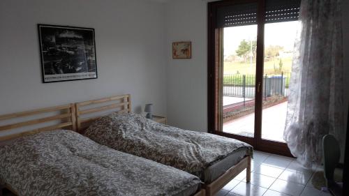 a bedroom with a bed and a large window at A Casa di Kate b&b in Pila