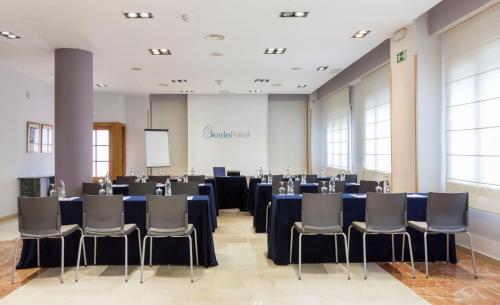 a conference room with blue tables and chairs at Porcel Torre Garden in Madrid