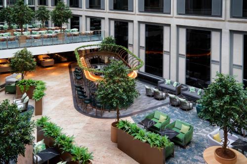 an overhead view of a hotel lobby with chairs and trees at Leonardo Royal London St Paul’s in London