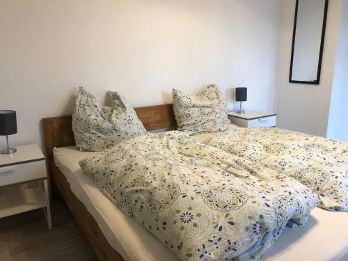 a bedroom with a bed with a comforter and pillows at Pension Jägerschenke in Luhe-Wildenau