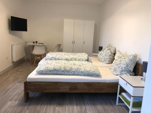 a bedroom with a bed with two pillows on it at Pension Jägerschenke in Luhe-Wildenau