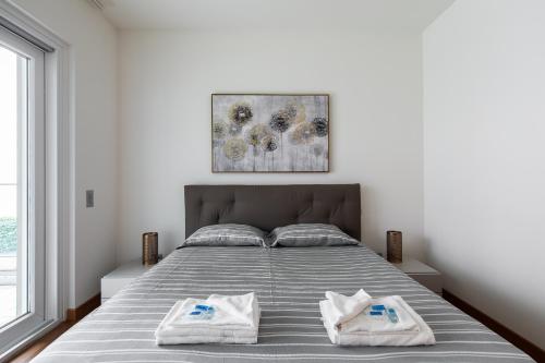 a bedroom with a bed with two towels on it at Prestige Apartments by Quokka 360 - spacious flats with terraces in Lugano