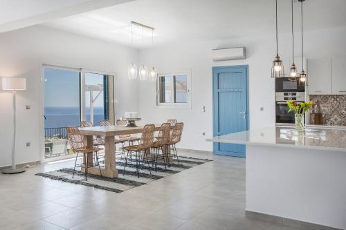 a kitchen and dining room with a table and chairs at Villa Apollonia in Fiskardho