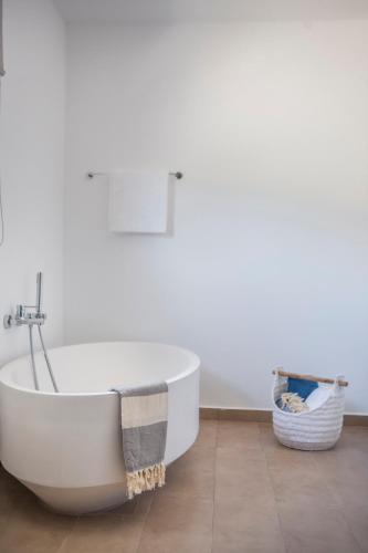 a white bath tub sitting in a bathroom at Villa Apollonia in Fiskardho