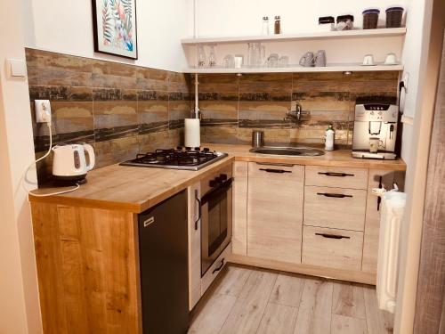 a kitchen with a sink and a stove top oven at SOLE in Żary