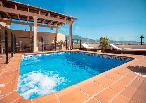 a swimming pool in a patio with a pergola at Spectacular views of the sea, Punta Lara, Nerja, Nº7 in Nerja