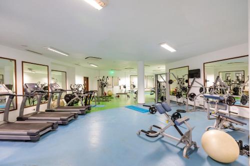 a gym with several treadmills and machines at Aliathon Aegean in Paphos City