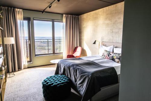 a bedroom with a bed and a large window at Hotell Södra Berget in Sundsvall