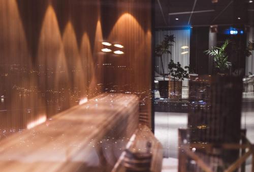 a blurry picture of a bar with a view of a city at Hotell Södra Berget in Sundsvall