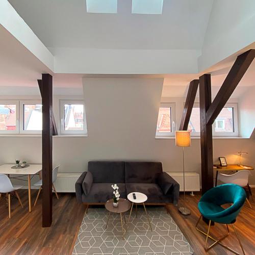 a living room with a couch and a table at Nurban Apartments Oldtown in Nürnberg