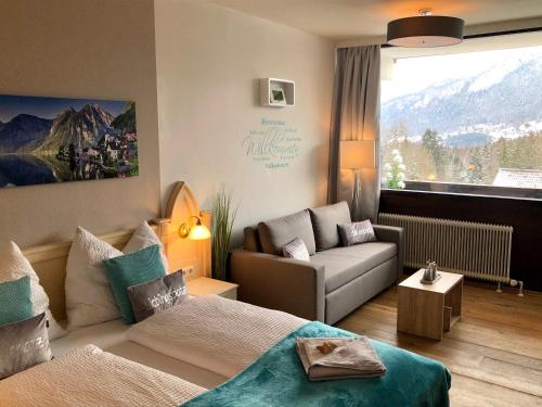 a living room with a bed and a couch at Apartment Goisernperle in Bad Goisern