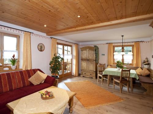 a living room with a couch and a table at Haus Jung - Chiemgau Karte in Inzell
