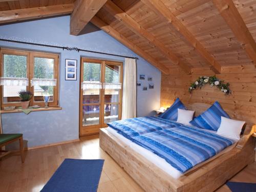 a bedroom with a large bed in a wooden room at Haus Jung - Chiemgau Karte in Inzell