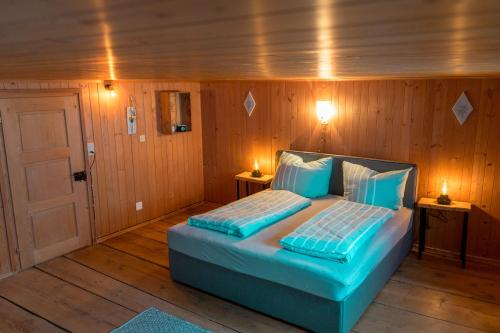 a bedroom with a bed in a room with wooden walls at Moserhuus in Furna