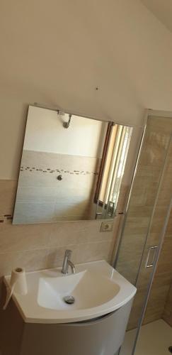 a bathroom with a sink and a mirror at Mare a Santa Margherita in Pula