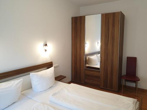 a bedroom with a bed and a large mirror at Ferienwohnungen Stranddistel - Apartments von 30 bis 75 qm in Zinnowitz