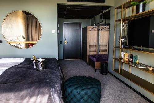 a hotel room with a bed and a mirror at Hotell Södra Berget in Sundsvall