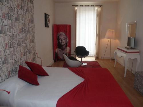a bedroom with a large white bed with red pillows at Evora Inn in Évora