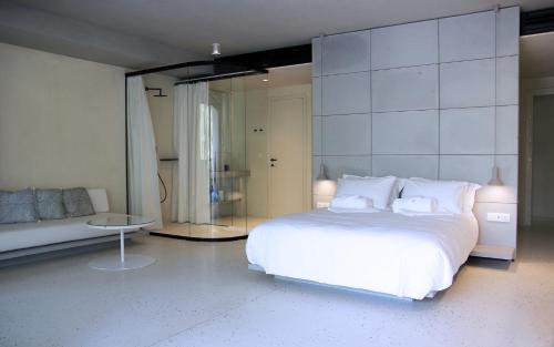 a bedroom with a white bed and a mirror at Ogarden in Athens