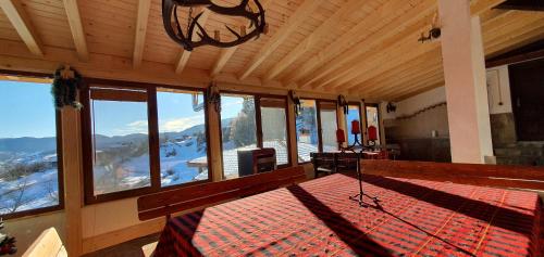 a room with a bed with a view of a mountain at Guest House Panorama in Gela