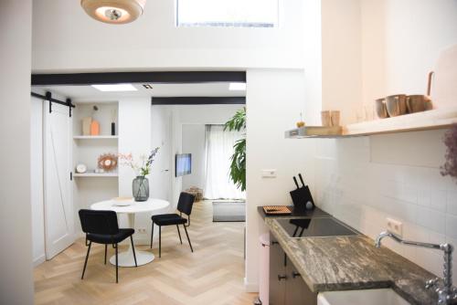 a kitchen and dining room with a table and chairs at In de bocht in Heiloo