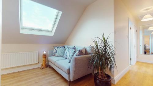 a living room with a couch and a window at Ross Beach Family Farmhouse B&B in Killala