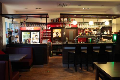 a bar with a counter and some chairs at Penzion Mova in Kadaň