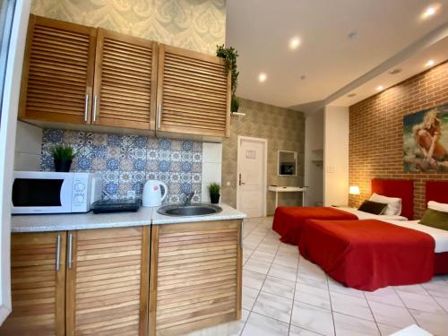 a kitchen with a microwave and a bed in a room at CityComfort Hotel Kitay- Gorod in Moscow