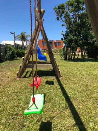 a swing set in a park with two swings at Las Pakas in La Paloma