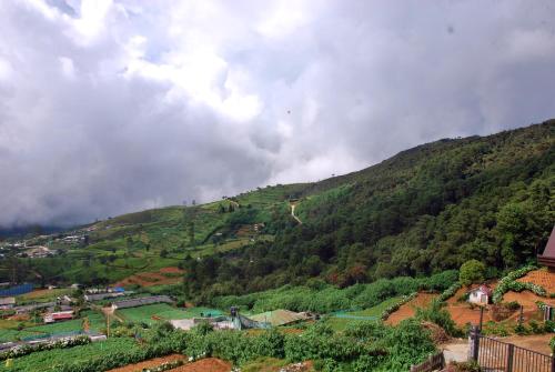 a view of a mountain with a town on it at Cottage San Francesco in Nuwara Eliya