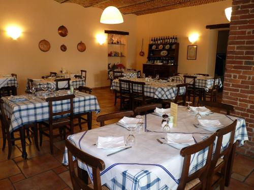 a dining room with tables and chairs in a restaurant at Locanda Occitana Cà Bianca in Roccabruna