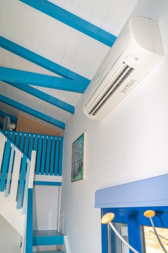 a room with blue and white ceilings and blue stairs at Iris Villas in Spárton