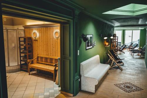 a living room with a couch and a chair at Hotel Sportalm - Adults Only Boutique Hotel in Bad Kleinkirchheim