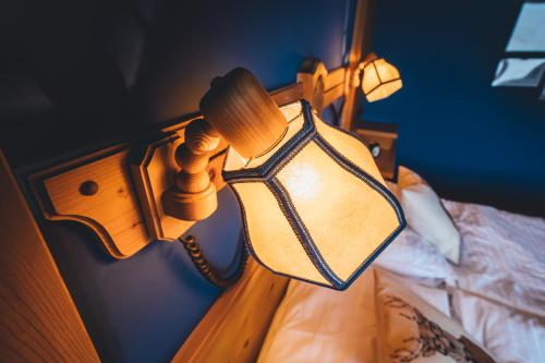 a lamp on the side of a bed at Hotel Sportalm - Adults Only Boutique Hotel in Bad Kleinkirchheim