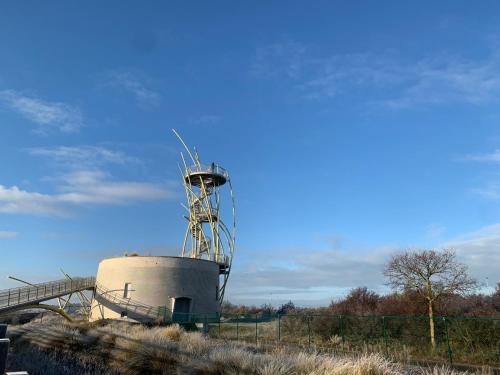 a silo sitting in the middle of a field at studio Zeedijk Emperador in Middelkerke