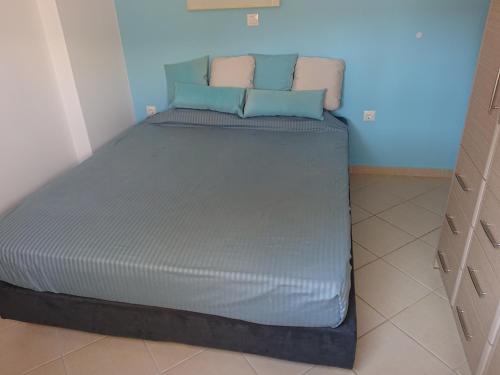 a bed with two pillows on it in a room at Iris Villas in Spárton