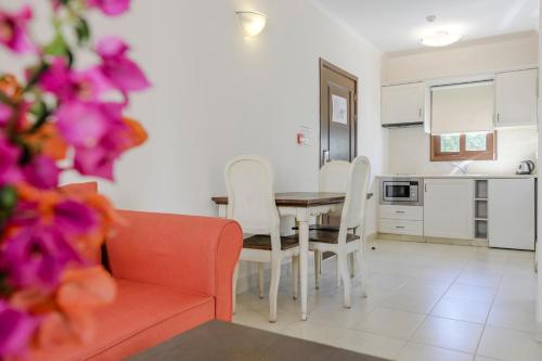 a kitchen and dining room with a table and chairs at Aliathon Ionian in Paphos City