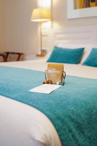 a laptop sitting on top of a bed at Hotel Villa Rosario, Palacete in Ribadesella