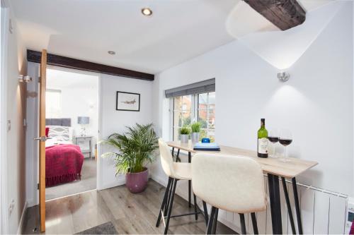 a kitchen and dining room with a table and chairs at Gateway Mews - Serviced Apartments in Kegworth