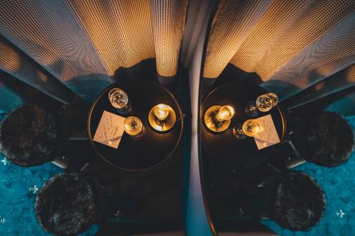 two tables with watches and candles on them at Hotel Sportalm - Adults Only Boutique Hotel in Bad Kleinkirchheim