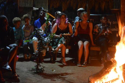 a group of people sitting around a fire at Lebo's Soweto Backpackers in Soweto