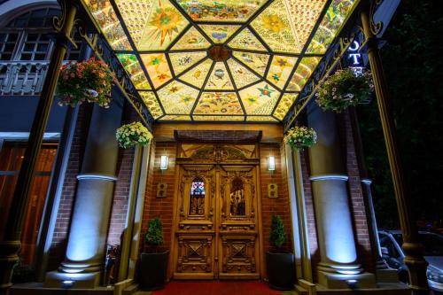 a building with a large wooden door with a ceiling at River Side Hotel Tbilisi in Tbilisi City