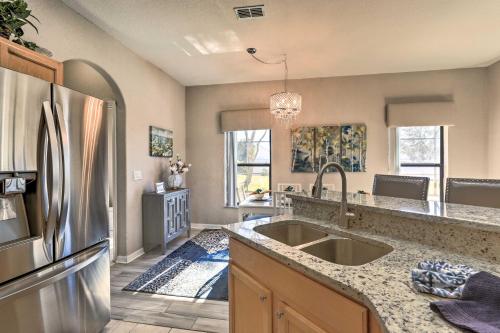 a kitchen with a sink and a refrigerator at Disney Villa with Game Room and Pool - 10 Mi to Parks! in Orlando