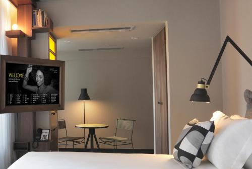 a bedroom with a bed and a table and chairs at Yoo2 Rio de Janeiro, Tapestry Collection by Hilton in Rio de Janeiro
