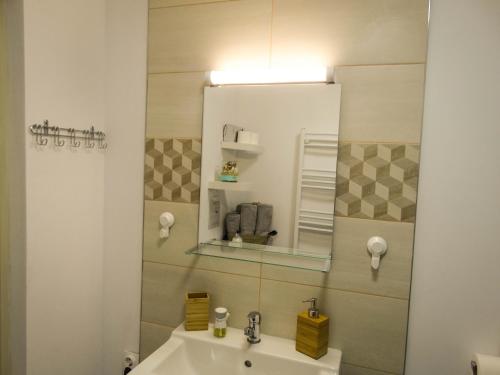 a bathroom with a sink and a mirror at Casa JOY in Râşnov