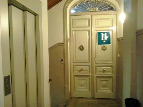 a door in a hallway with a sign on it at Hostal Alonso No Limit Madrid in Madrid