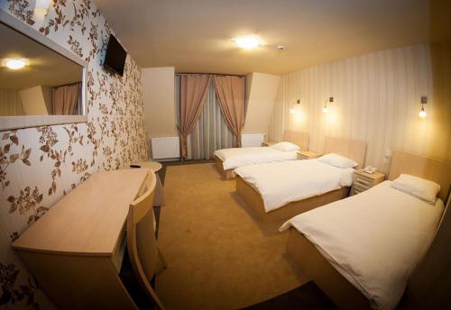 Postel nebo postele na pokoji v ubytování Hotel Regent
