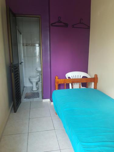 a bedroom with a bed and a bathroom with a toilet at Capao da canoa Apto. 3 dorm in Capão da Canoa